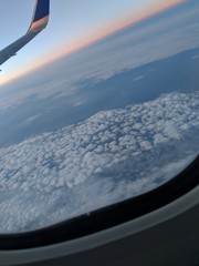 Naklejka na ściany i meble Plane in the clouds