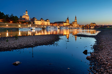 Fototapeta na wymiar Dresden city skyline in blue hour from the river with rocks