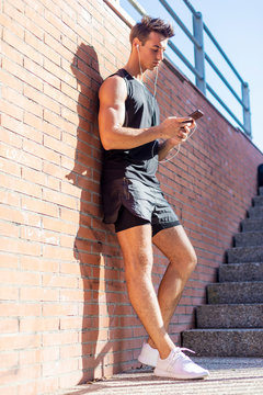 Portrait of a young man checking sport results on smartphone