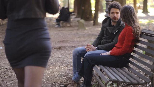jealous woman arguing with boyfriend in the park,he looking another woman