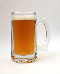 Glass of light beer on a white background, close-up