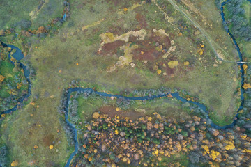 Aerial view with a drone. Winding river with autumn forest, top view