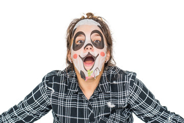 Young teenage girl with facial panda mask looking at camera isolated on white background. Cosmetic...