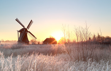 Dutch windmill at frosty winter sunrise - obrazy, fototapety, plakaty