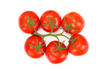 Top view of red fresh tomatoes with green leaves isolated on white background