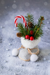 Little Christmas tweed retro boot with fir tree branches, cones and candy canes, postcard concept