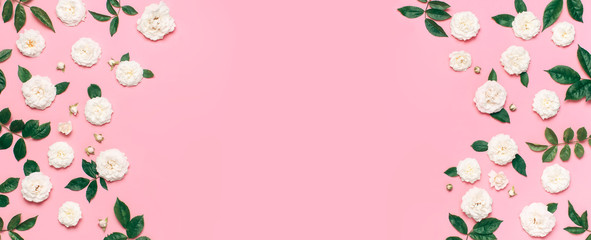 Frame of Flowers composition. White fresh roses and green leaves on gentle pink background. Flat lay, top view, copy space. Flower card, greeting, holiday mockup. Valentine's Day background womens day