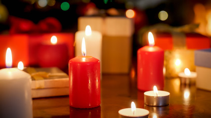 Beautiful background for Christmas with burning red and white candles