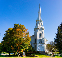 classic New England white church in fall foliage