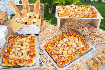 trays with tomato and mozzarella pizzas, rustic with wustel, basket with various shapes of bread