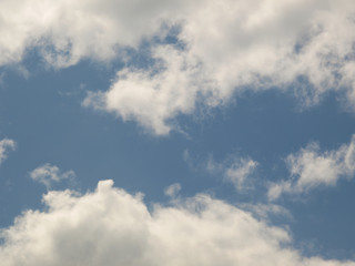 Summer background with white flying clouds on blue sky. Romantic natural heaven backdrop.