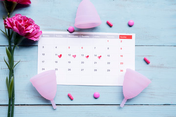 Calendar with cups, roses, and pain relief pills