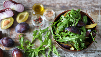 Healthy autumn salad with arugula and plum. Selective focus. Macro.