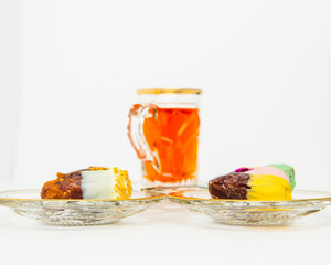 tea with saffron, sweet dates on crystal plates, golden design, chocolate bites
