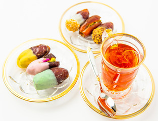 tea with saffron, sweet dates on crystal plates, golden design, chocolate bites