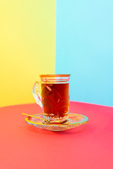 tea with saffron, crystal vintage teacup, crystal plate with golden design, silver spoon