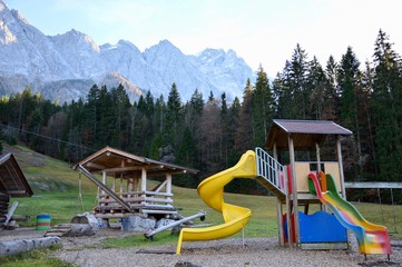 Children playground in park close to mountains