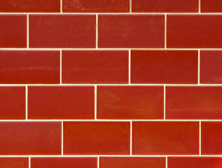 Obraz premium Red ceramic brick tile wall. colorful wall tiles design for bathroom, washroom and kitchen. Background from slate natural stone tile for outdoor wall