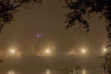 The bavarian city of Regensburg before dawn covered in dense autumn fog