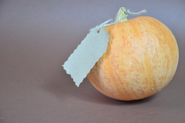 Thanksgiving Day. Pumpkin, pumpkin with autumn leaves and apples. Autumn harvest on a brown background. Happy Thanksgiving Lettering set table for celebration. fork and knife