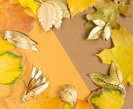 Woman's Jewelry. Vintage jewelry autumn background. Beautiful gold brooches on yellow background. Flat lay, top view with copy space.