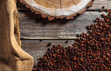 Coffee beans on the wooden table.