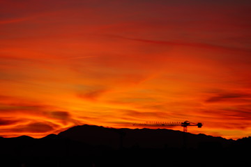 clouds sunset crane atardecer nubes multicolor y grua de la construccion malaga andalucia españa