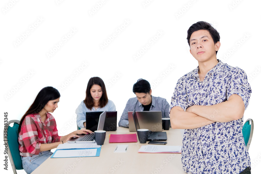 Wall mural Male confident entrepreneur with his team on studio