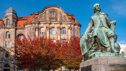 Statue of great scientist Otto Guericke in Magdeburg in red and golden Autumn colors, Germany