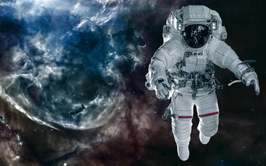 Fototapeta premium Astronaut on background of nebula. Deep cosmic landscape. Science fiction. Elements of this image furnished by NASA