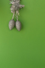 Christmas composition. Silver shiny Christmas decorations on green vertical background.