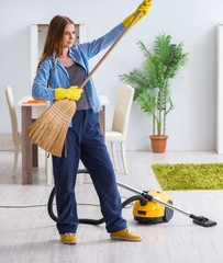 Young woman cleaning floor at home doing chores
