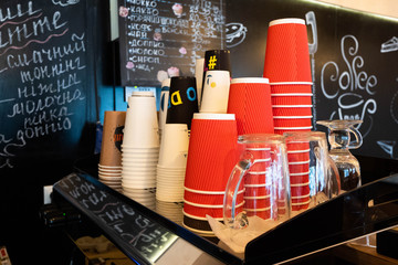 Many disposable paper cups of different sizes