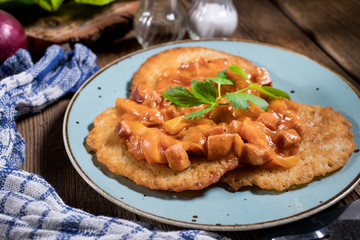 Homemade potato pancakes with goulash.