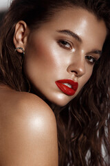 Beautiful sexy girl with bright makeup, red lips, wet hair. Beauty face.