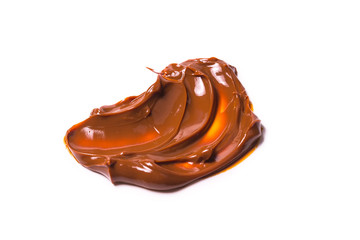 Melted tasty caramel splashes isolated on white background.