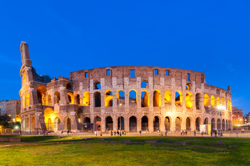 Fototapeta na wymiar The Colosseum in Rome, Italy at sunset twilight. Blue hour photo in the evening. The world famous colosseum landmark in Rome.