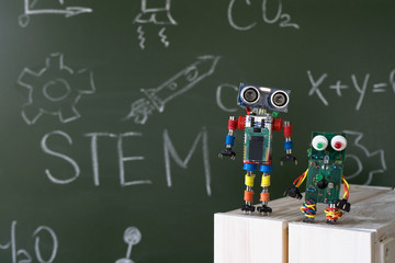 Back to school concept. A metal robot and an electronic board that can be programmed. Robotics and electronics. DIY robotics. STEM and STEAM education for kids. Free space for text.