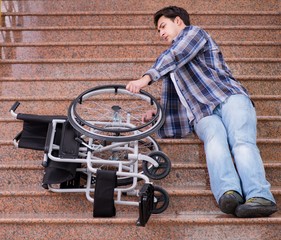 Disabled man on wheelchair having trouble with stairs
