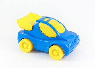  Blue toy plastic car with yellow wheels and yellow glass. Children toy