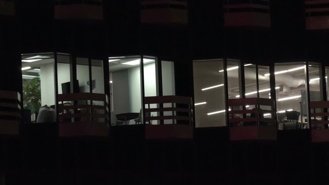 View of office windows at night in an empty building
