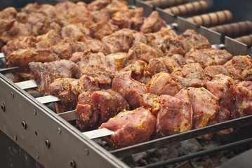 Barbecue fries in the coals. Meat and beef at the field kitchen festival.