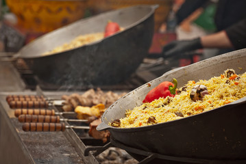 Large cauldron floating at the city fair. Red peppers, garlic, meat and incas in porridge.
