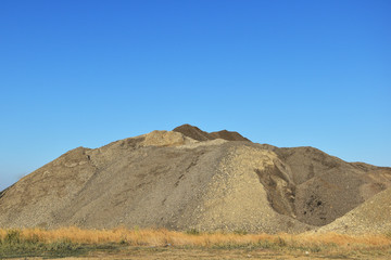 A huge pile of yellow sand and no one.