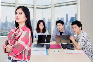 Young confident businesswoman with her team