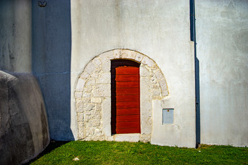 old wooden door in the vintage stone wall