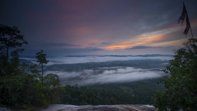 Time-lapse of moving stratus clouds across over the small city, view from Baha camp,mount Stong, Kelantan Malaysia during sunrise.