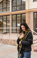 Fototapeta na wymiar girl with a yellow scarf walks the city