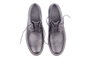 Classic leather elegant shoe on a white background. Beautiful black luxury and casual leather men shoes. Fashion accessory. Top view. Both legs. Isolated.