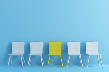 outstanding yellow chair among light blue chair. Chairs with one odd one out in light blue color room. - obrazy, fototapety, plakaty